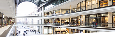 Modern Shopping Mall with stores, Cafe and Shoppers Walking Around